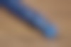Close up detail of the twist on the top of the blue pen.